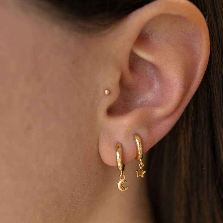 The Land of Salt Star and Moon Huggie Hoops in Gold